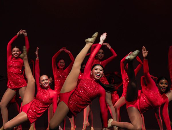 Sophomore and Corporal Hailey Wong executes a floor during Varsity’s Jazz dance to “Burnin’ Up” on stage. “We had a lot of morning practices and after school rehearsals to prepare for the show,” Wong said. “In these practices we ran through every dance and re-spaced them to fit on the stage since we are usually dancing on gym floors.”