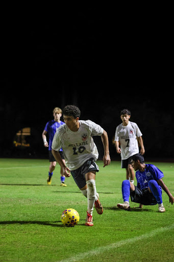 Senior Sayf Elkousy dribbles the ball down the field looking for an open teammate. Elkousy has been captain of the varsity boys' soccer team since sophomore year.